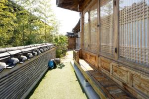 a row of benches on the side of a building at HakMinJae Hanok Stay in Seoul