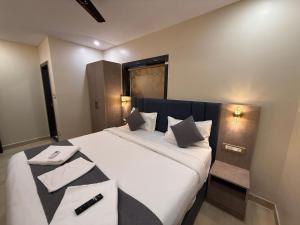 a bedroom with a large bed with white sheets and pillows at Mio Boutique Hotel - Just Launched in Hyderabad