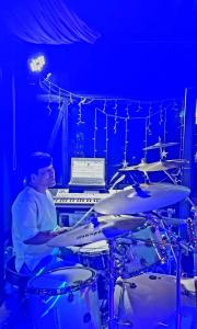 a man playing drums in a blue room at Seosan View Live in Seosan +35 photos