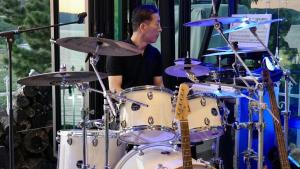a man playing a drum set on a stage at Seosan View Live in Seosan