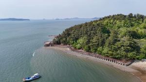 a boat in the water next to an island at Seosan View Live in Seosan