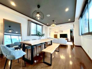 a dining room and living room with a table and chairs at Yokohama Mega Stay in Yokohama