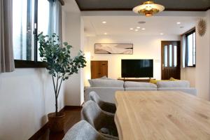a living room with a couch and a table at Yokohama Mega Stay in Yokohama