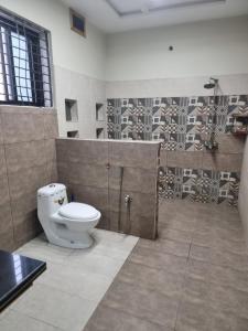 a bathroom with a toilet and a shower at Elegance Abounds in Qila Malla Singh