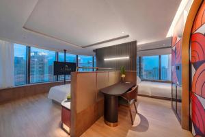 a hotel room with a bed and a desk in it at Atour Hotel Shanghai City Center ATHOUSE嘉邸 in Shanghai