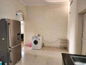 a kitchen with a washing machine in a room at Contemporary comfort in Kākināda +2 photos