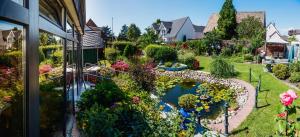 a garden view from a window of a house at Gasper Business & Garden Hotel in Raunheim