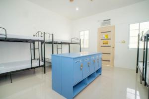 a hospital room with two bunk beds and a table at Liberty's Homestay Private Apartment in Coron