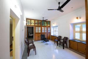 a living room with chairs and a waiting room at Thaayar Homestay by Highpoint in Tiruchirappalli