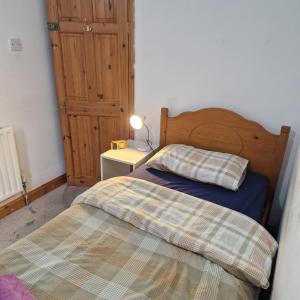 a bedroom with a bed and a table with a lamp at Balfour House in Leicester