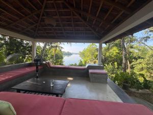 a screened in porch with a view of a lake at Cinnamon lodge rooms in Koggala