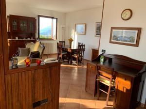 a living room with a desk and a table at Casa Vacanze a Luino - Casa di Adele in Luino