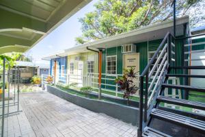a house with a green and white building at Liberty's Homestay Private Apartment in Coron