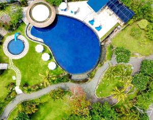 an overhead view of a swimming pool in a park at Blue Point Resort and Spa in Uluwatu