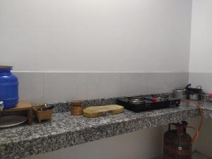 a kitchen counter with a stove and some items on it at Viki homestay in Dimapur