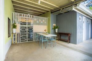 a patio with a table and chairs in a building at Liberty's Homestay Private Apartment in Coron