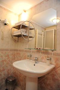 a bathroom with a sink and a mirror at Millenium Palace in Ohrid