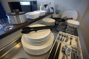 a kitchen with plates and utensils on a counter at The Grand Win in Fukuoka +62 photos