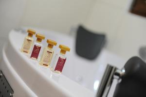 a group of four bottles of oils sitting on a counter at Millenium Palace in Ohrid