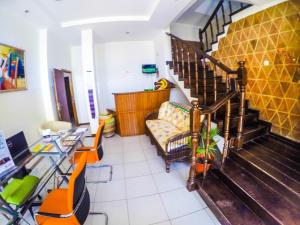 a waiting room with a staircase and a couch at Atlantic Maio Hotel in Vila do Porto