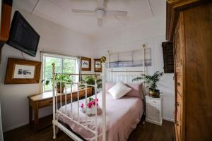 a bedroom with a bed with flowers on it at Jaspers Apartments in Brunswick Heads