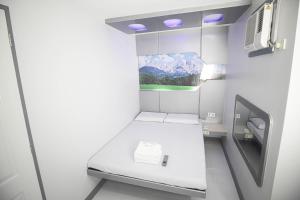 a small room with a bed in a bathroom at Astrotel Calamba in Calamba