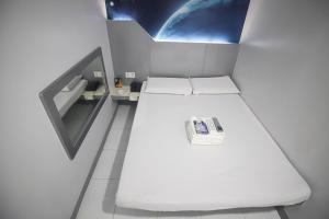 a room with two beds in a space station at Astrotel Calamba in Calamba