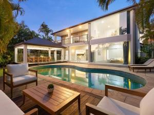 an exterior view of a house with a swimming pool at Capri Garden Stay in Gold Coast