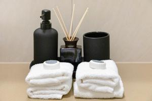 a pair of towels and a bottle of soap at Nature's Nest - Pool - SPA - Outdoor Kitchen and Dining in Leanyer +49 photos
