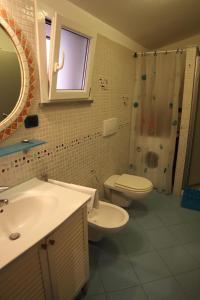 een badkamer met een wastafel, een toilet en een douche bij La Casina della Tagià in Manarola
