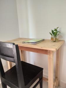 a wooden desk with a potted plant and a book at Viki homestay in Dimapur +3 photos