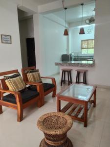a living room with two chairs and a table at Viki homestay in Dimapur