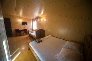 a small room with a bed and a couch in it at Hotel Nikala in Tskaltubo +86 photos