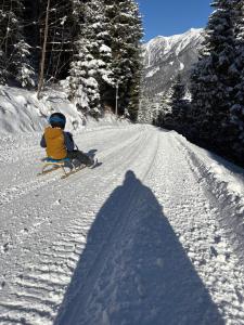a person on skis sitting on a snow covered slope at Mallnbach Apartments in Mallnitz +151 photos