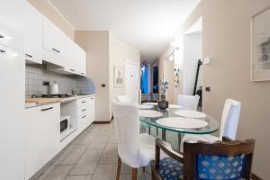 a kitchen and dining room with a table and chairs at Piazza Pontida - City Center - Meliora Apartments in Bergamo +46 photos