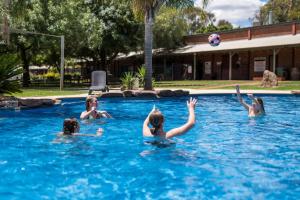 a group of children playing with a volley ball in a swimming pool at Tasman Holiday Parks - Merool on the Murray in Echuca