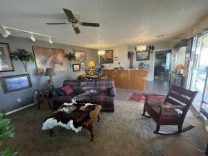 a living room with a couch and a dog laying on a table at Cherokee Inn in Cherokee