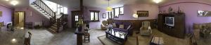 a living room with purple walls and stairs at La Posada de Cucayo in Dobres