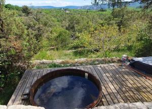 a wooden tub sitting on top of a wooden deck at Le Trible in Labeaume