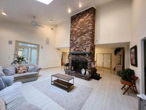 a large living room with a brick fireplace at Eagles Nest Mansion in Montgomery