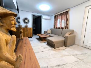 a living room with a couch and a table at Glyki Canyon Bungalow in Antimácheia