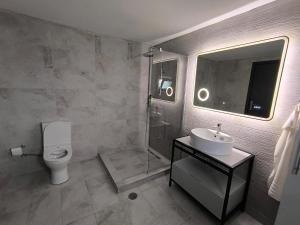 a bathroom with a toilet and a sink and a shower at Glyki Canyon Bungalow in Antimácheia +37 photos
