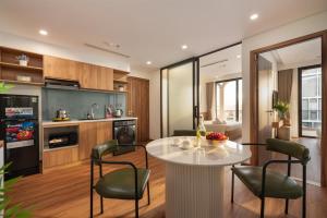 a kitchen and living room with a table and chairs at Grand Lux by BRIO in Danang