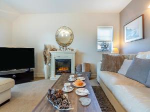 a living room with a couch and a fireplace at The Paddock in Bodelwyddan