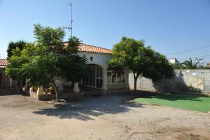 a house with trees in front of it at The House in Casas Devesa