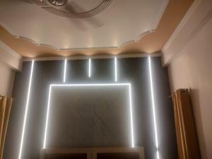 a room with a wall with lights on it at Tapovan Lightning room by yog tapovan in Rishīkesh