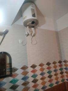 a bathroom with a light on the corner of a room at Tapovan Lightning room by yog tapovan in Rishīkesh