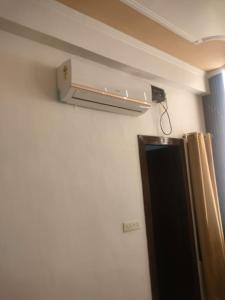 a room with a air conditioner on the wall at Tapovan Lightning room by yog tapovan in Rishīkesh