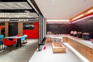 a restaurant with red and blue chairs and a table at Ibis Beijing Tiananmen Square in Beijing