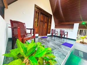 a living room with chairs and a table at Sigiriya On Rock Villa in Sigiriya